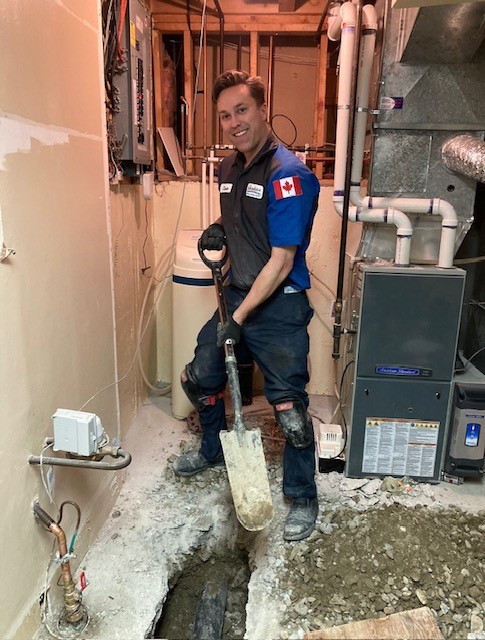 Calgary plumber at work on drain line